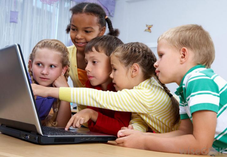 Kids around a donated computer in Regina