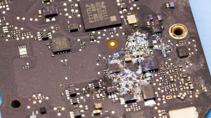 Corrosion quickly starts if not dealt with after spilling water on a Macbook Pro motherboard in Regina