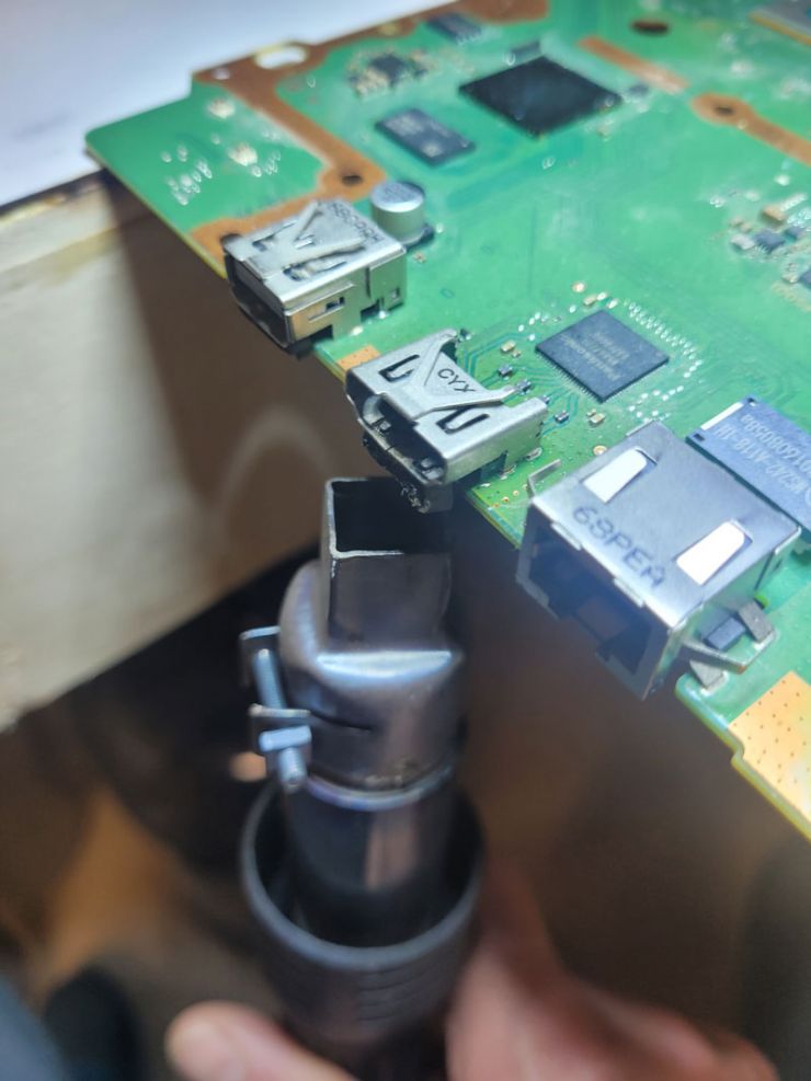 Using a hot air station we are able to safely remove a damaged HDMI port from this gaming console
